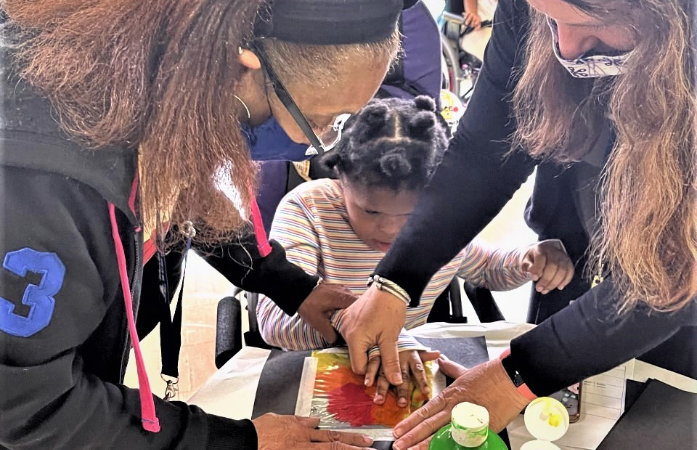  Staff helping a student with an activity